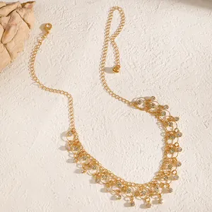 Detailed view of an elegant gold-plated necklace with sparkling zirconia tassel charms