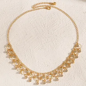 Detailed view of a elegant gold clavicle chain necklace with sparkling zircon tassels.