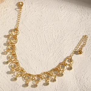 Detailed view of gold tassel necklace with sparkling cubic zirconia and geometric links.