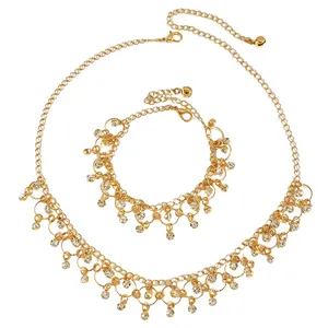 Detailed view of gold tassel necklace and bracelet set with sparkling zircon charms