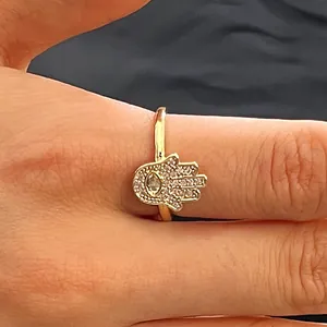 Detailed macro view of gold Hamsa hand ring featuring pavé-set cubic zirconia stones