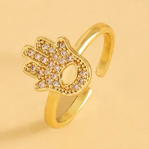Detailed close-up of a gold Hamsa Hand ring featuring micro-pave zirconia evil eye design.