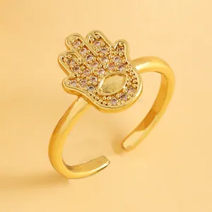Detailed close-up of gold Hamsa hand ring featuring micro-pave zircons and evil eye motif