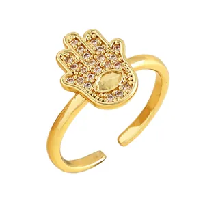 Macro view of golden Hamsa hand ring with sparkling micro-paved cubic zirconia detail