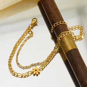 Detailed close-up of double-layer Cuban chain anklet with gold flower charm