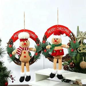 Festive Christmas wreaths with knitted gingerbread man dolls on rattan rings decoration