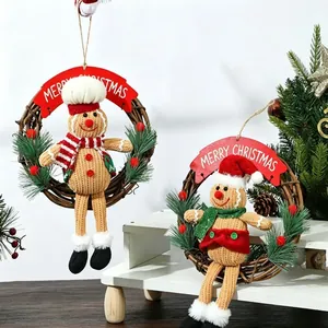 Detail of two gingerbread man Christmas wreaths with festive hats and scarves