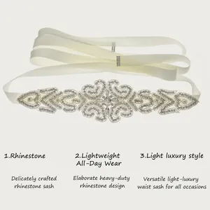 Detailed view of an elegant handmade wedding dress sash with intricate rhinestone patterns.
