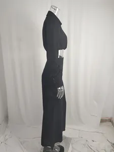 Side view of black long-sleeve crop shirt and high-waisted wide-leg trousers set