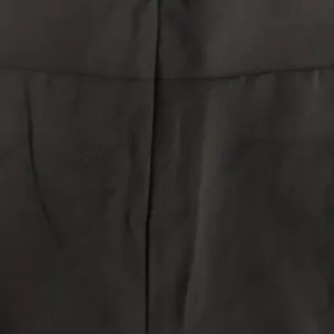 Close-up detail of black fabric texture and seam for casual women's set