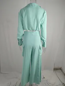 Back view detail of the mint green wide-leg pants and cropped long-sleeved shirt set
