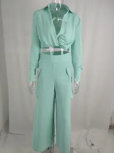 Mint green two-piece outfit with long sleeve crop top and wide leg cargo pants