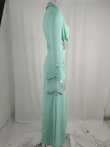 Side view of a mint green two-piece outfit featuring a long-sleeve shirt and wide-leg trousers