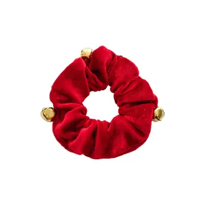 Elegant red velvet Christmas scrunchie with gold bells for festive hair styling and gifts