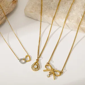 Detailed view of vintage-style stainless steel necklaces with heart and bow pendants.