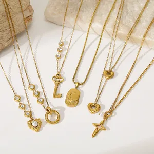 Detailed view of various vintage gold stainless steel necklaces with unique pendants.