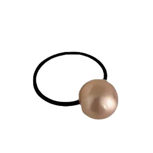 Elegant hair tie featuring a metallic champagne brushed sphere on black elastic band