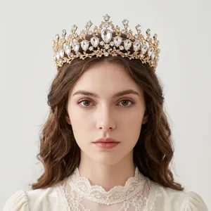 Elegant model wearing a vintage Baroque gold crown adorned with teardrop rhinestones