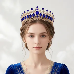Vintage baroque gold crown with blue teardrop rhinestones worn by elegant model