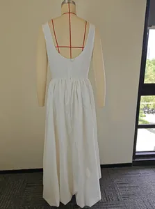 Back view of elegant white sleeveless maxi dress on a mannequin with U-neck design