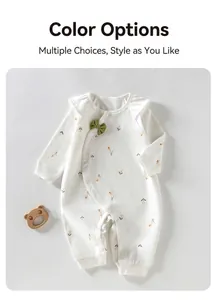 Macro view of adorable baby girl cotton romper with soft floral print and green bow