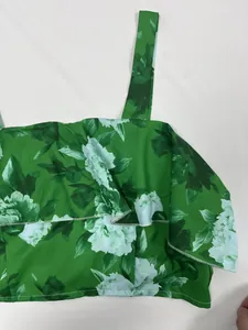 Détail de haut élégant à fleurs vertes avec un design à volants très élégant