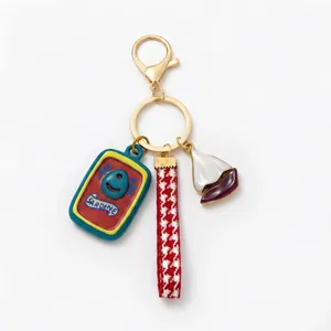 Detail view of a nautical-themed keychain with sardine can and sailboat charms