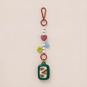 Detailed view of a colorful ocean-themed bag charm accessory with fish tin and heart