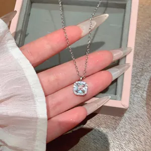 Close-up of a square light blue gemstone pendant on a silver chain in detail view