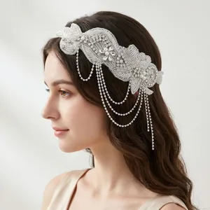 Close-up of luxury white rhinestone headband with dangling crystal tassel chains.