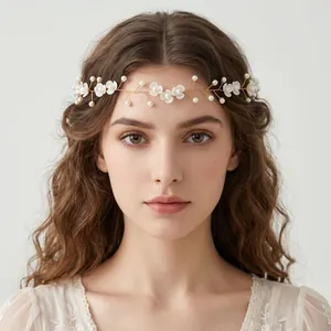 Detailed view of handmade bridal floral vine headband with pearls and white blossoms
