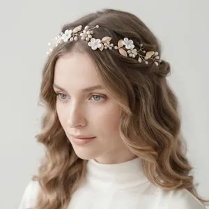 Handmade bridal hairband with white flowers and pearls in a forest vine design