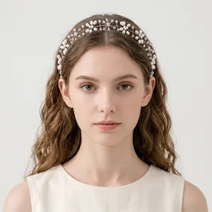 Handmade elegant bridal vine headband with pearls and crystals on a female model