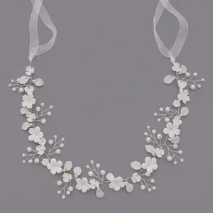 Elegant handmade bridal hair vine with white flowers and pearls for wedding hairstyles.