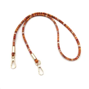 Detailed view of ethnic style beaded lanyard with gold lobster clasps
