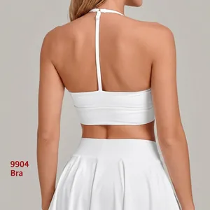 White yoga sports bra with adjustable straps and matching tennis skirt, back view showing design