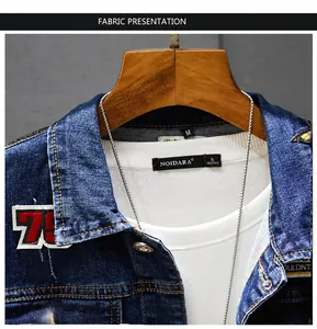 Close-up of men's denim jacket featuring fabric texture and embroidered badge details