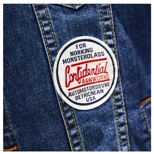 Close-up detail of the vintage style embroidered circular patch on blue denim jacket