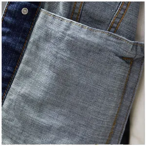 Close-up of premium denim fabric texture and stitching on men's casual jacket pocket