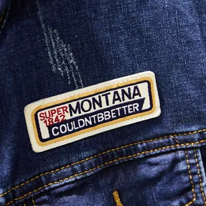 Detailed close-up view of a blue denim jacket for men with a stylish Montana patch.
