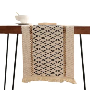 Boho cotton linen table runner with geometric diamond pattern and decorative tassels.