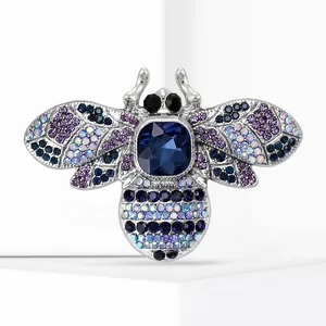 Macro view of colorful bee brooch with sparkling blue and purple rhinestones