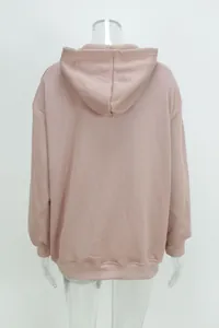 Back view of a loose-fitting dusty pink hooded sweatshirt featuring ribbed cuffs and hem detail.