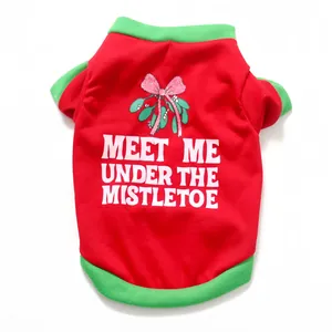 Detail of red Christmas dog T-shirt featuring mistletoe print and vibrant green trim
