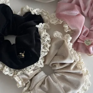 Elegant set of three velvet hair scrunchies with delicate lace trim in black pink and beige