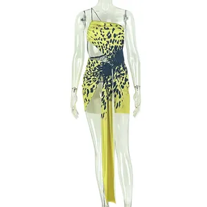 Close-up detail of yellow leopard print mini dress with asymmetrical hem and ruched waist