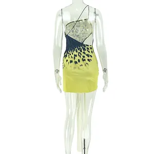 Detailed back view of a yellow and black leopard print backless mini dress with strap