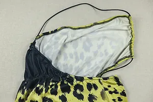 Detailed view of the leopard print fabric and stitching on a short bodycon dress.