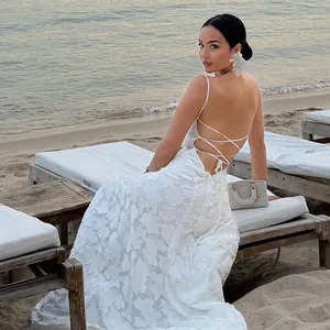 Detailed view of elegant white floral lace backless evening dress with cross-strap design