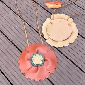 Detailed view of cute flower-shaped children's crossbody bags in soft litchi grain leather.